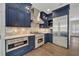 Modern kitchen with stainless steel appliances and blue cabinetry at 727 Park Lake Cir, Orlando, FL 32803
