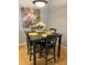 Small dining area with dark brown square table and four grey chairs at 1990 Erving Cir # 201, Ocoee, FL 34761
