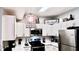 Modern kitchen with white cabinets and stainless steel appliances at 1990 Erving Cir # 201, Ocoee, FL 34761