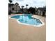 Community swimming pool with stairs and handrails at 1990 Erving Cir # 201, Ocoee, FL 34761