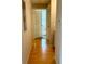 Light and bright hallway with wood flooring leading to bedrooms at 1990 Erving Cir # 201, Ocoee, FL 34761