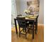Small dining area with dark brown square table and four grey chairs at 1990 Erving Cir # 201, Ocoee, FL 34761