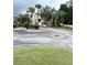 Community parking lot with landscaping and entryway at 1990 Erving Cir # 201, Ocoee, FL 34761