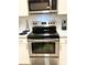 Stainless steel kitchen appliances including a microwave, oven, and stovetop at 1990 Erving Cir # 201, Ocoee, FL 34761