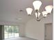Bright living room with vaulted ceiling, ceiling fan and sliding glass doors leading to patio at 11188 Hess Way, Oxford, FL 34484