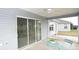 Covered screened porch with ceiling fan and outdoor seating area at 11188 Hess Way, Oxford, FL 34484