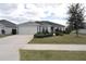 One-story house with gray siding and landscaped yard at 11188 Hess Way, Oxford, FL 34484