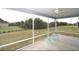Spacious screened porch overlooking backyard with a view of the landscape at 11188 Hess Way, Oxford, FL 34484