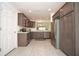 Well-equipped kitchen featuring dark wood cabinets and modern flooring at 11188 Hess Way, Oxford, FL 34484