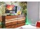 Media wall in a bedroom with a large TV and jungle mural, creating a fun atmosphere at 4837 Dedication St, Kissimmee, FL 34746