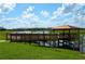Relaxing lakeside gazebo with a wooden walkway at 4837 Dedication St, Kissimmee, FL 34746