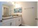 Double vanity with gray countertop and white cabinets in a bright bathroom at 4837 Dedication St, Kissimmee, FL 34746