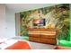 Jungle-themed media wall with a large TV and dresser, perfect for entertainment at 4837 Dedication St, Kissimmee, FL 34746