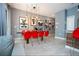 Open concept dining area with red chairs and Mickey Mouse art at 4837 Dedication St, Kissimmee, FL 34746