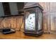 Snowy owl in a glass lantern on a wooden table at 4837 Dedication St, Kissimmee, FL 34746