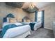 Two twin beds, patterned wallpaper, and a unique ceiling design create a whimsical bedroom at 4837 Dedication St, Kissimmee, FL 34746