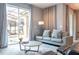 Living room with gray sofa and view of the pool through sliding doors at 4837 Dedication St, Kissimmee, FL 34746
