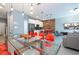 Open concept kitchen and dining area with modern appliances and glass dining table at 4837 Dedication St, Kissimmee, FL 34746
