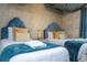 Two twin beds in a well-lit bedroom with decorative wall accents at 4837 Dedication St, Kissimmee, FL 34746