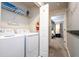Laundry room with washer, dryer, and shelving at 4837 Dedication St, Kissimmee, FL 34746