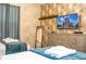 Two twin beds, a TV, and dresser in a themed bedroom with patterned walls at 4837 Dedication St, Kissimmee, FL 34746