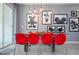 Red chairs and a glass table with Mickey Mouse art at 4837 Dedication St, Kissimmee, FL 34746