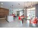 Open concept dining area with red chairs and a glass table at 4837 Dedication St, Kissimmee, FL 34746