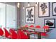 Glass dining table with red chairs and Mickey Mouse decor at 4837 Dedication St, Kissimmee, FL 34746