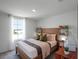 Cozy bedroom with a wooden bed frame and large window at 2738 Flushing Dr, Apopka, FL 32703