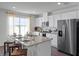 Modern kitchen featuring granite countertops, stainless steel appliances, and an island with seating at 2738 Flushing Dr, Apopka, FL 32703