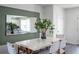 Bright dining room with white table, woven chairs, and a large mirror at 2738 Flushing Dr, Apopka, FL 32703
