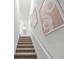Modern staircase with wall art and a large mirror at 2738 Flushing Dr, Apopka, FL 32703