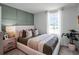 Serene bedroom with a white bed frame and green accent wall at 2738 Flushing Dr, Apopka, FL 32703