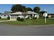 Single-story home with attached garage and street view at 20505 Queen Alexandra Dr, Leesburg, FL 34748