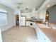 Bright kitchen with white cabinets, tile floor, and appliances at 20505 Queen Alexandra Dr, Leesburg, FL 34748
