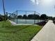 Tennis court with chain-link fence at 20505 Queen Alexandra Dr, Leesburg, FL 34748