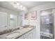 Double vanity bathroom with granite countertop and shower at 936 Paradise Dr, Davenport, FL 33897