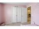 Bright bedroom with two closets and access to a hallway at 936 Paradise Dr, Davenport, FL 33897