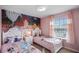 Charming twin beds with princess bedding, and Ariel mural at 936 Paradise Dr, Davenport, FL 33897