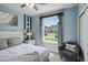 Bright bedroom with a queen bed, large window, and ceiling fan at 936 Paradise Dr, Davenport, FL 33897