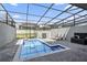 Private screened pool and patio area with lounge chairs and grill at 936 Paradise Dr, Davenport, FL 33897