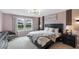 Bright bedroom with a queen bed, dresser, and window view at 936 Paradise Dr, Davenport, FL 33897