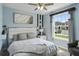 Spacious bedroom with a queen bed and large window offering natural light at 936 Paradise Dr, Davenport, FL 33897