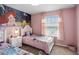 Charming bedroom with twin beds, themed decor, and ample closet space at 936 Paradise Dr, Davenport, FL 33897
