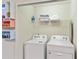 Bright laundry room with washer, dryer, and storage at 936 Paradise Dr, Davenport, FL 33897