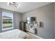 Bedroom with mounted TV, dresser, and window with view at 936 Paradise Dr, Davenport, FL 33897