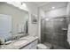 Modern bathroom with granite countertop, large mirror, and shower at 936 Paradise Dr, Davenport, FL 33897