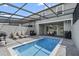 Private, screened-in pool with patio and grilling area at 936 Paradise Dr, Davenport, FL 33897