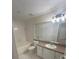 Bathroom with bathtub, toilet, and vanity with sink at 5578 Metrowest Blvd # 107, Orlando, FL 32811