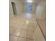 Spacious living room with tile flooring and large window at 5578 Metrowest Blvd # 107, Orlando, FL 32811